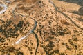 Aerial View Curved River In Early Spring Landscape. River bends Curves and dry grass landscape. Top View Of Beautiful