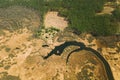 Aerial View Curved River In Early Spring Landscape. River bends Curves and dry grass landscape. Top View Of Beautiful