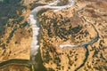 Aerial View Curved River In Early Spring Landscape. River bends Curves and dry grass landscape. Top View Of Beautiful