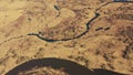 Aerial View Curved River In Early Spring Landscape. River bends and dry grass landscape. Top View Of Beautiful European