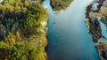 Aerial View Curved River In Early Spring Landscape. River bends and pine forest landscape. Top View Of Beautiful