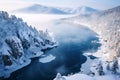Aerial view of curved river between mountains with coniferous forest covered with shiny snow in winter Royalty Free Stock Photo