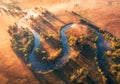 Aerial view of curving river in fog at sunrise in autumn Royalty Free Stock Photo