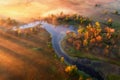 Aerial view of curving river in fog at sunrise in autumn Royalty Free Stock Photo