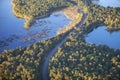 Aerial view of curving road between lakes and trees in autumn color in northern Minnesota