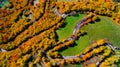 View of curvy road in beautiful autumn forest . Top view of roadway with autumn colors. European roads Royalty Free Stock Photo