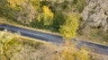 Aerial view of curvy road in forest. Autumn high in mountains Royalty Free Stock Photo