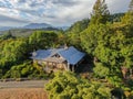 Aerial view of cute classic American wood house in the mountain and surrounded by forest.