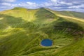 Aerial view of Cwm Llwch lake below the summits of Pen-y-Fan and Corn Du in the Brecon Beacons, Wales