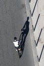 Aerial view of cyclist on the road with shadows