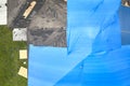 Aerial view of damaged in hurricane Ian house roof covered with blue protective tarp against rain water leaking until Royalty Free Stock Photo