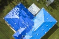 Aerial view of damaged in hurricane Ian house roof covered with blue protective tarp against rain water leaking until Royalty Free Stock Photo