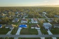 Aerial view of damaged in hurricane Ian house roof covered with blue protective tarp against rain water leaking until Royalty Free Stock Photo