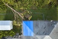 Aerial view of damaged in hurricane Ian house roof covered with blue protective tarp against rain water leaking until Royalty Free Stock Photo