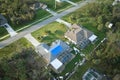 Aerial view of damaged in hurricane Ian house roof covered with blue protective tarp against rain water leaking until Royalty Free Stock Photo