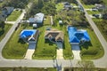 Aerial view of damaged in hurricane Ian house roof covered with blue protective tarp against rain water leaking until Royalty Free Stock Photo