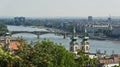 Aerial view of the Danube river, bridge, church and roofs in Budapest, sunny day, Hungary