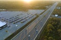 Aerial view of dealership parking lot with many brand new cars for sale near wide american highway. Development of US Royalty Free Stock Photo