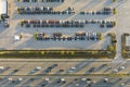 Aerial view of dealership parking lot with many brand new cars for sale near wide american highway. Development of US Royalty Free Stock Photo