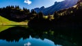 Aerial view of deep blue mountain lake in swiss alps with house, switzerland Royalty Free Stock Photo