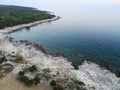 Aerial view of a deep sea near a dense green forest Royalty Free Stock Photo