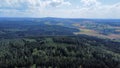 Aerial view of dense green forests and agricultural fields against a cloudy sky in Saxony, Germany Royalty Free Stock Photo