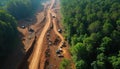 Aerial view devastation from deforestation. Earthmovers, trucks cut through forest, destroying trees. Environmental degradation, Royalty Free Stock Photo
