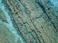 Aerial view of a dinghy in the water floating on a transparent sea. Bathers at sea. Zambrone, Calabria, Italy Royalty Free Stock Photo