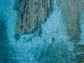 Aerial view of a dinghy in the water floating on a transparent sea. Bathers at sea. Zambrone, Calabria, Italy Royalty Free Stock Photo