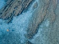 Aerial view of a dinghy in the water floating on a transparent sea. Bathers at sea. Zambrone, Calabria, Italy Royalty Free Stock Photo