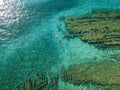 Aerial view of a dinghy in the water floating on a transparent sea. Bathers at sea. Zambrone, Calabria, Italy Royalty Free Stock Photo