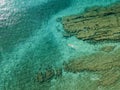 Aerial view of a dinghy in the water floating on a transparent sea. Bathers at sea. Zambrone, Calabria, Italy Royalty Free Stock Photo