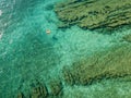 Aerial view of a dinghy in the water floating on a transparent sea. Bathers at sea. Zambrone, Calabria, Italy Royalty Free Stock Photo