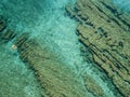 Aerial view of a dinghy in the water floating on a transparent sea. Bathers at sea. Zambrone, Calabria, Italy Royalty Free Stock Photo