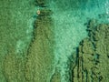 Aerial view of a dinghy in the water floating on a transparent sea. Bathers at sea. Zambrone, Calabria, Italy Royalty Free Stock Photo