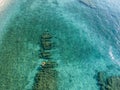 Aerial view of a dinghy in the water floating on a transparent sea. Bathers at sea. Zambrone, Calabria, Italy Royalty Free Stock Photo