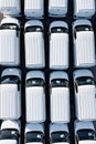 Aerial view directly above rows of new white vans ready for export and import