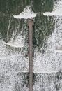 Aerial view directly above Saltburn Pier with rolling waves Royalty Free Stock Photo