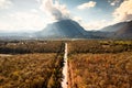 Aerial view of Doi Luang Chiang Dao mountain with the road among the autumn forest on bright day at Chiang Dao