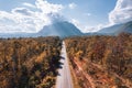 Aerial view of Doi Luang Chiang Dao mountain with straight road among autumn forest on bright day at Chiang Dao