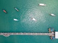 Aerial view of dolphin bridge with boats anchored at Chalong Pier