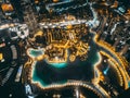 Aerial view of Downtown Dubai with roads, Dubai Mall and the fountain by night, from Burj Khalifa observatory deck in Royalty Free Stock Photo