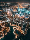 Aerial view of Downtown Dubai with roads, Dubai Mall and the fountain by night, from Burj Khalifa observatory deck in Royalty Free Stock Photo