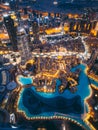 Aerial view of Downtown Dubai with roads, Dubai Mall and the fountain by night, from Burj Khalifa observatory deck in Royalty Free Stock Photo