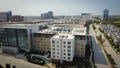 Aerial view downtown Plano, Texas along Legacy West with multistory apartment building, modern villas, glass office buildings,