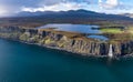 Aerial view of the dramatic coastline at the cliffs by Staffin with the famous Kilt Rock waterfall - Isle of Skye - Royalty Free Stock Photo