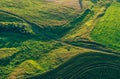 Aerial view from drone or aerostat in countryside rural farmland with green field hills and meadows, top view landscape