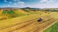 Aerial view, drone view of agriculture harvesting. Worker and farmer using tractor on harvest crops