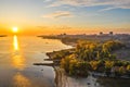 Aerial view from drone amazing sunrise over of the suburbs with the city under fog, giant smoke stack in industrial area, far