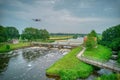 An aerial view with drone in the background above a weir in the river Vecht in the Netherlands. Downstream